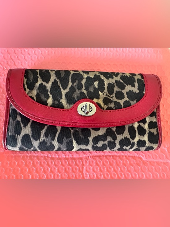 Coach Handbags - Coach Park Ocelot Print w/Red
Trim Bi-Fold Wallet with Turn Lock Closure